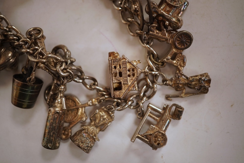 A white metal hunter keywind pocket watch, with Roman dial and subsidiary seconds, two silver charm bracelets and sundry items including jewellery and a silver sovereign case.